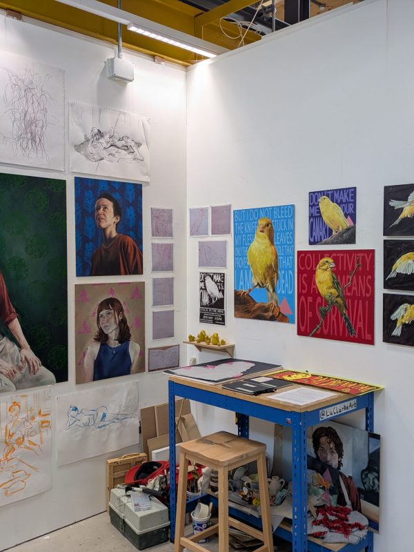Inside of studio full of paintings